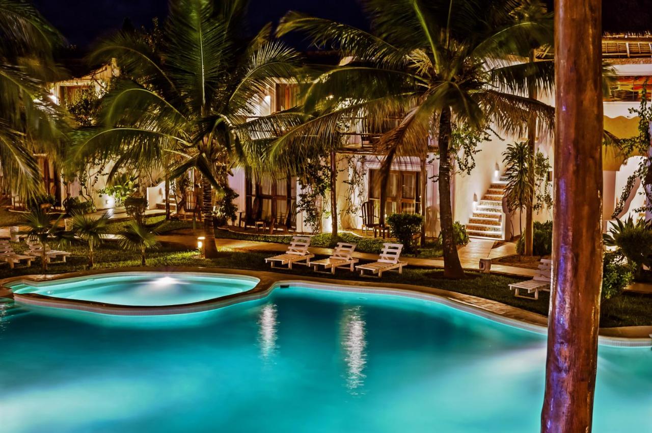 Pool and bar surrounded by palms at My Blue Hotel