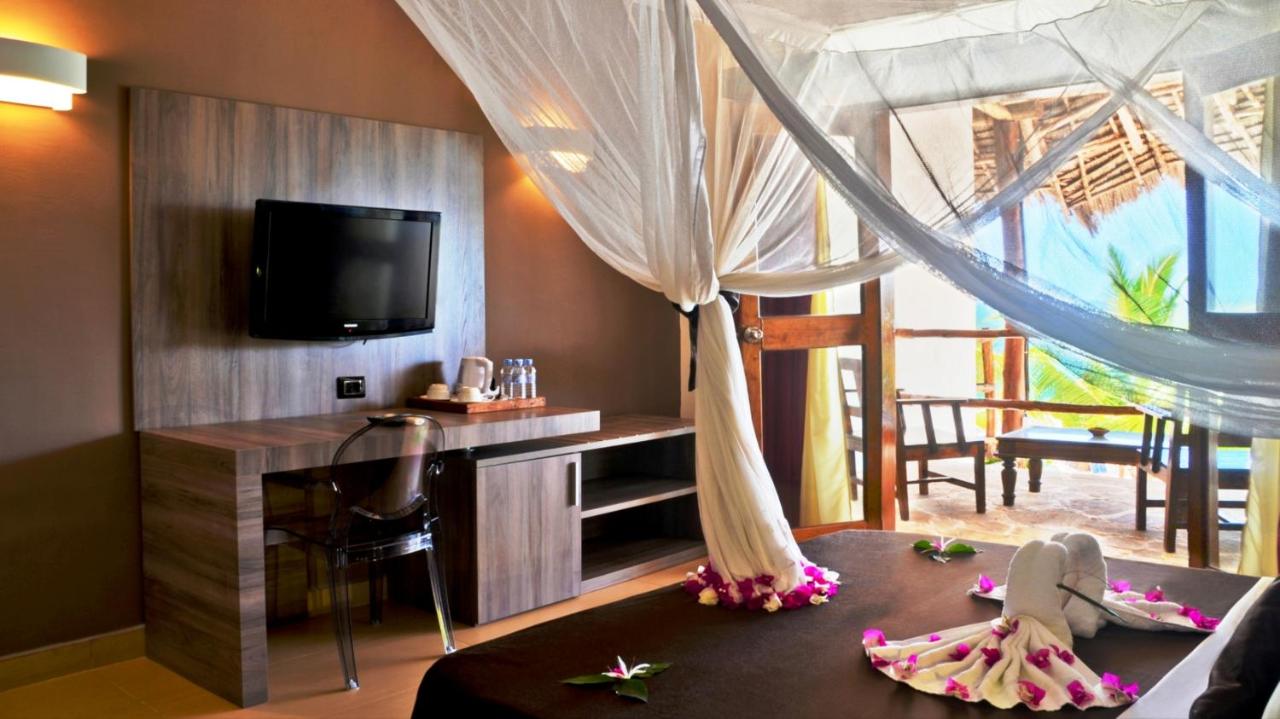 Ocean View Room with a four-poster bed and a window onto the sea