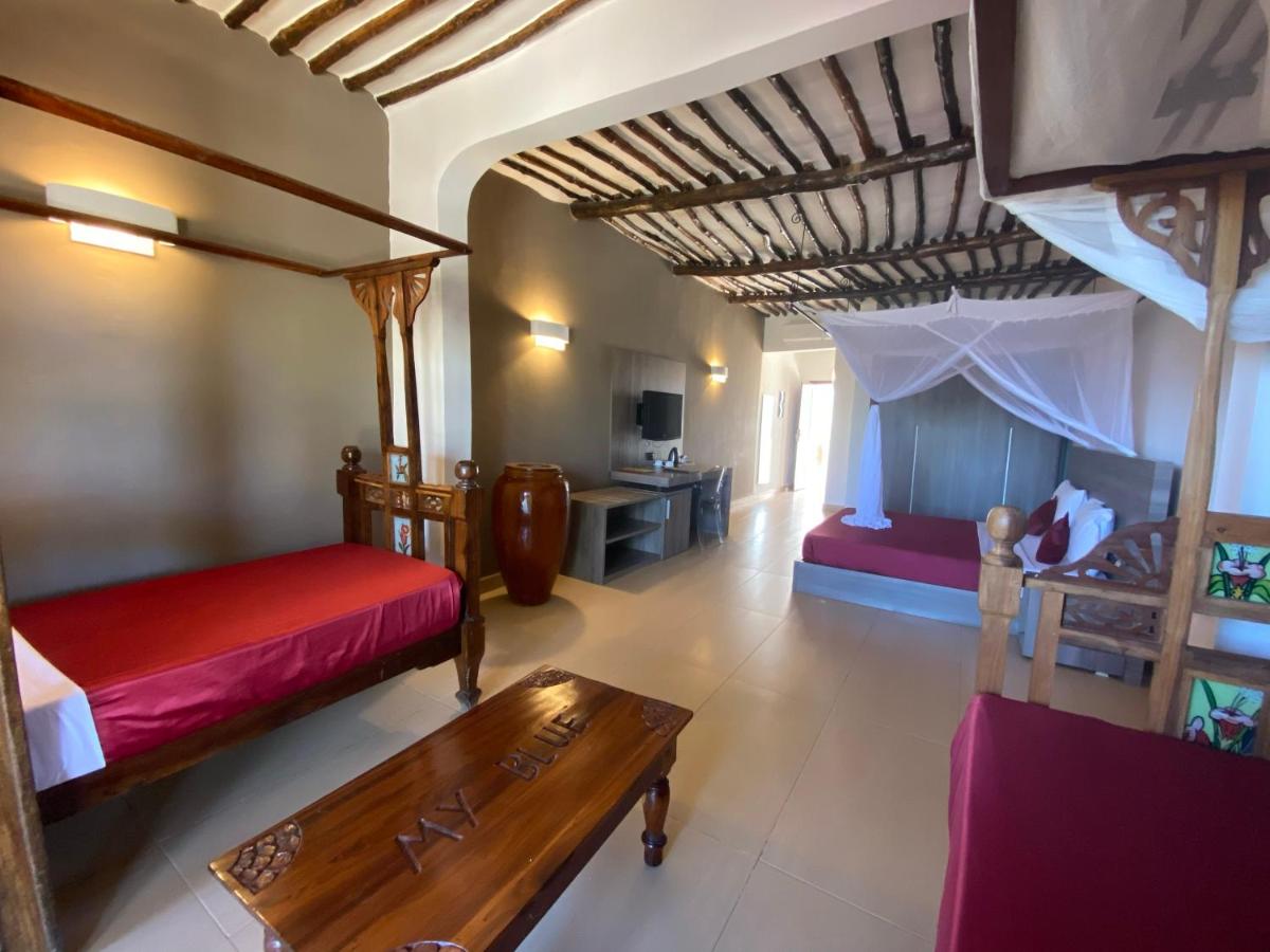 Bright Deluxe Room with a makuti ceiling and garden light